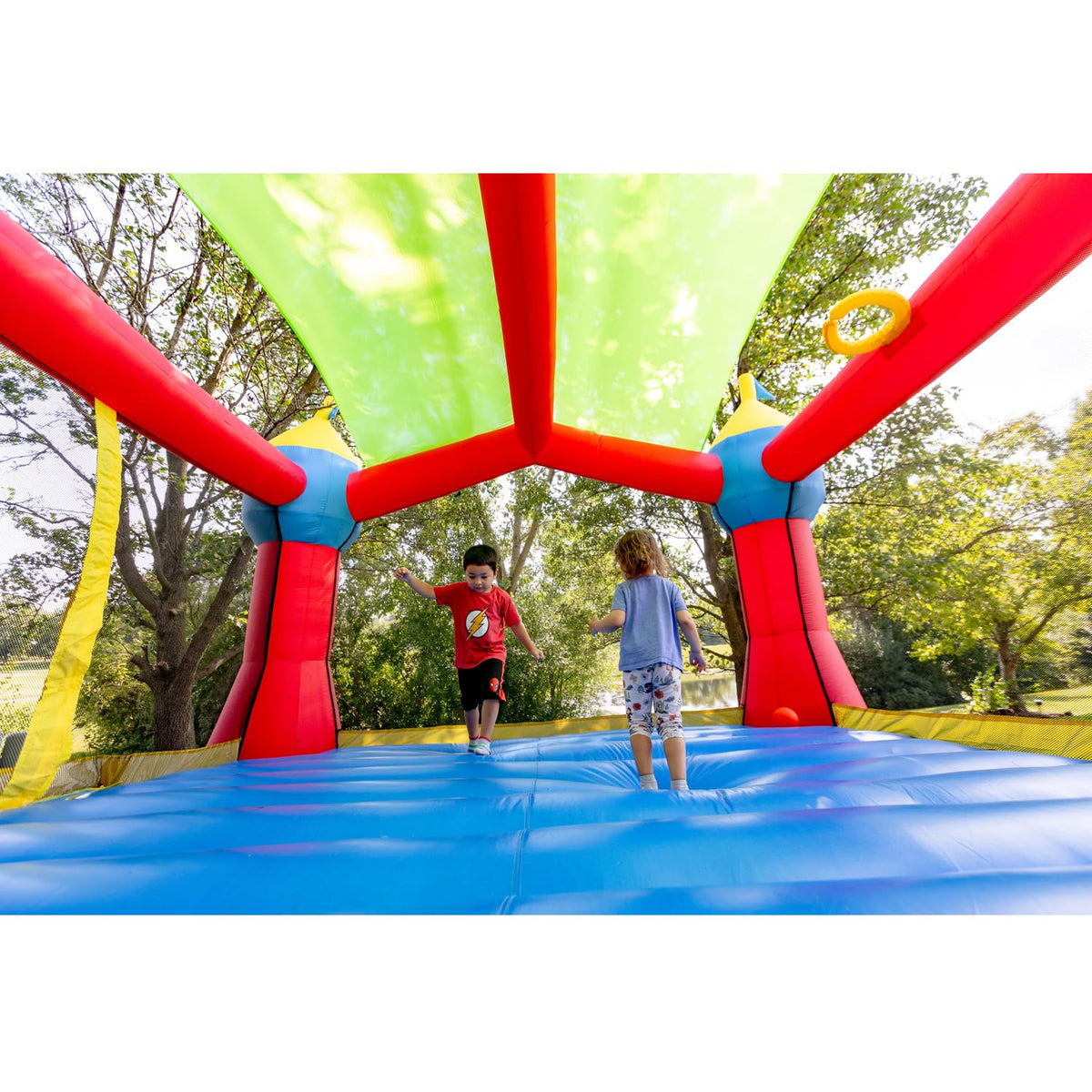 Bounceland Inflatable Party Castle Bounce House Bouncer, 16 ft L x 13 ft W x 10.3 ft H, Basketball Hoop, Removable Sun Roof, UL Strong Blower included, Fun Slide and Bounce Area, Castle Theme for Kids