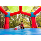 Bounceland Inflatable Party Castle Bounce House Bouncer, 16 ft L x 13 ft W x 10.3 ft H, Basketball Hoop, Removable Sun Roof, UL Strong Blower included, Fun Slide and Bounce Area, Castle Theme for Kids